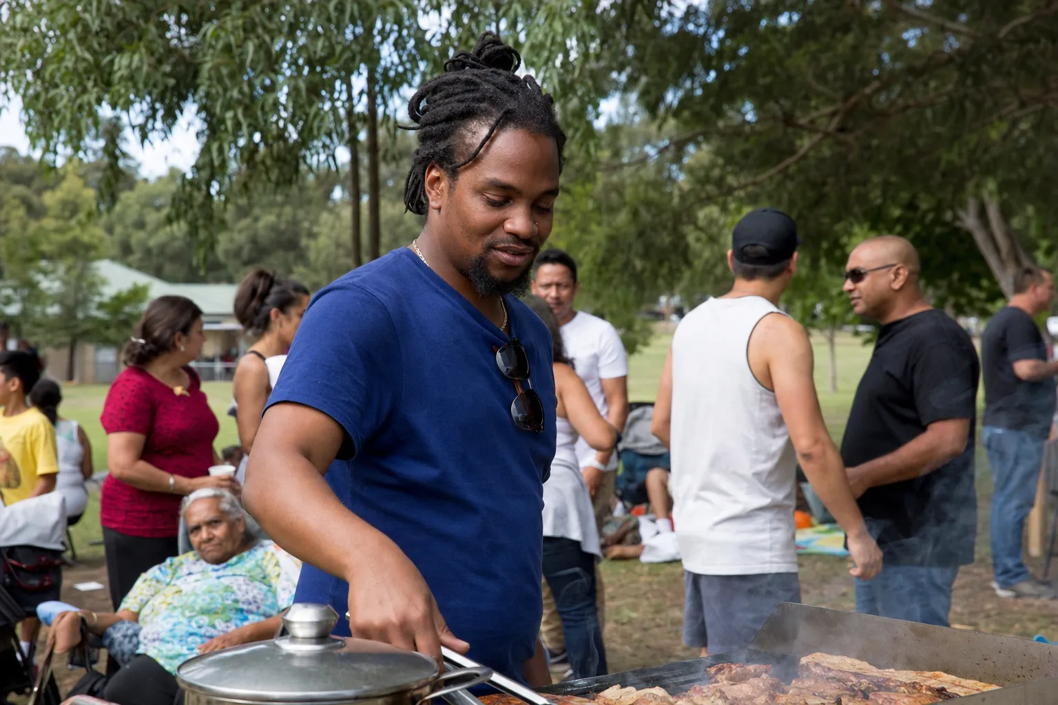 Community barbecue gathering with African-Australian families in a Melbourne park